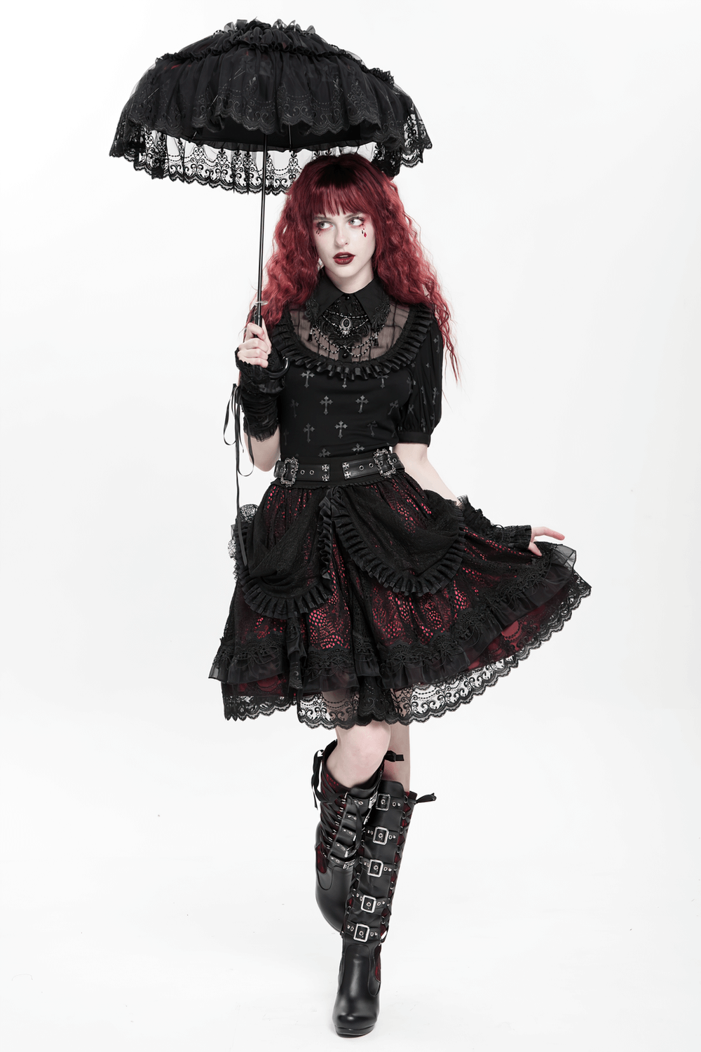 Gothic lace skirt with black ruffles, layered design, and red underlayer, paired with a stylish black parasol.