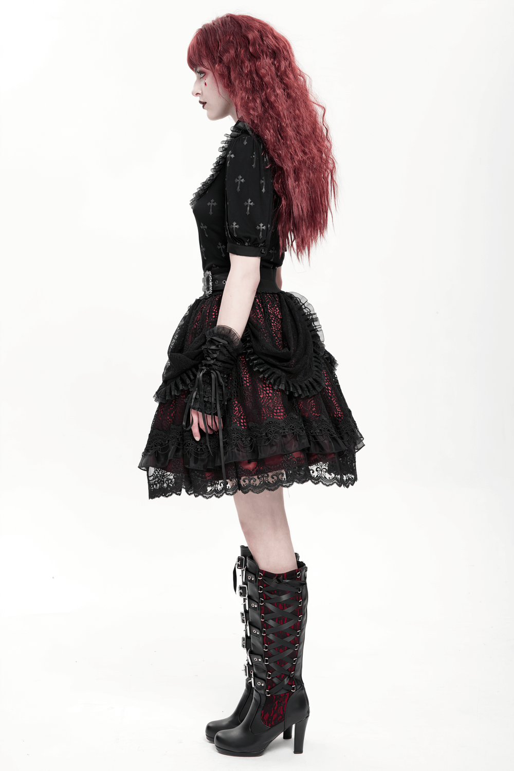 Gothic lace skirt with black ruffles, layered design, and red underlayer, styled with statement boots.