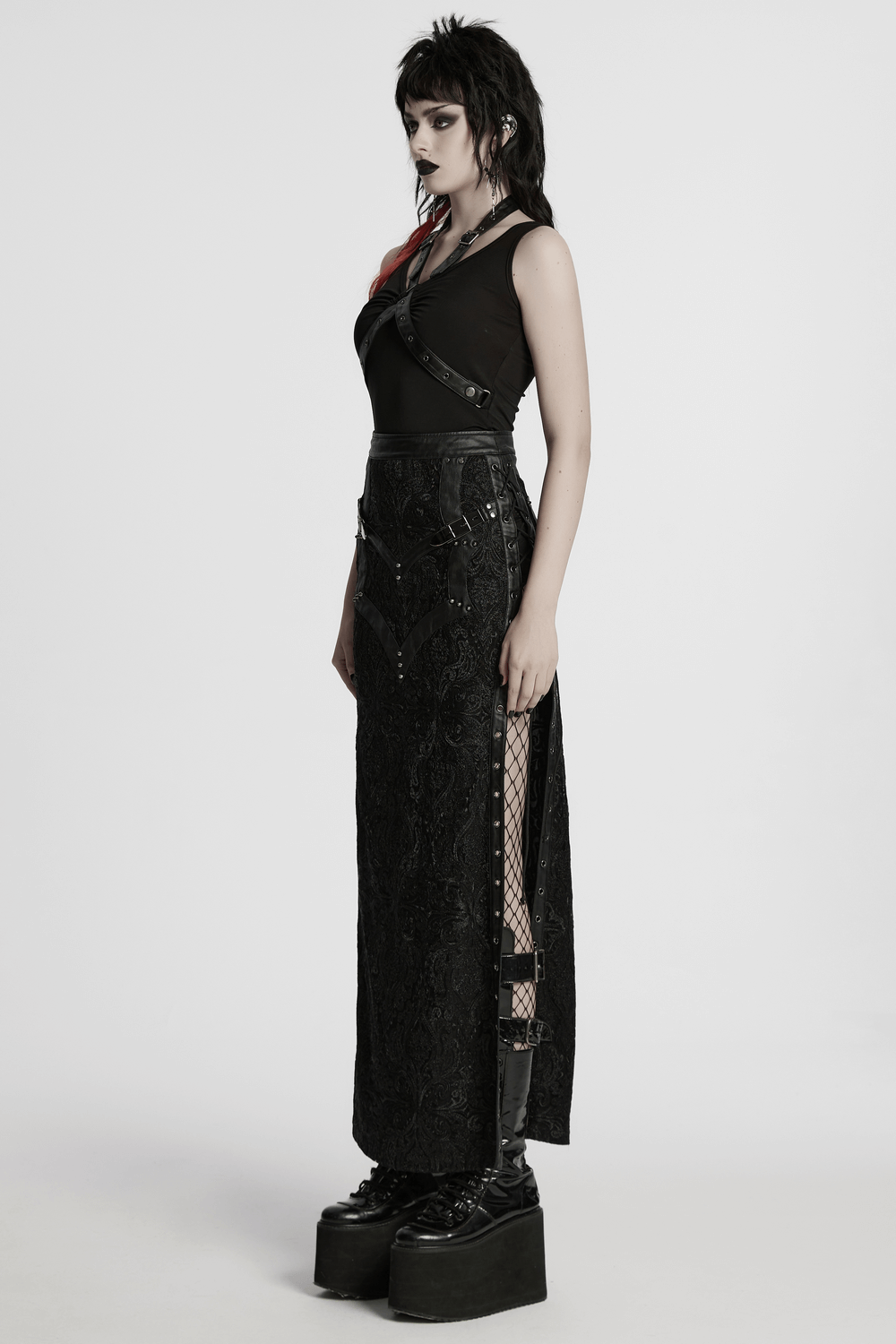 Gothic lace skirt featuring buckle detail and side slits, paired with a stylish black top and bold platform shoes.