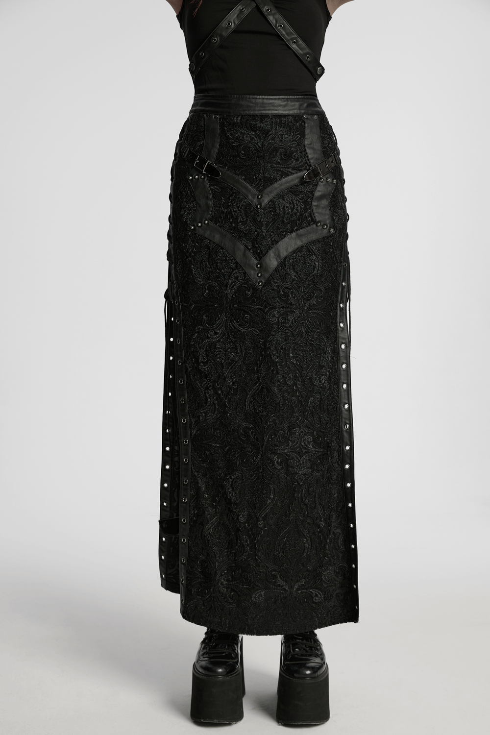 Gothic lace skirt with buckle details, side slits, and embroidered design, paired with chunky platform boots.