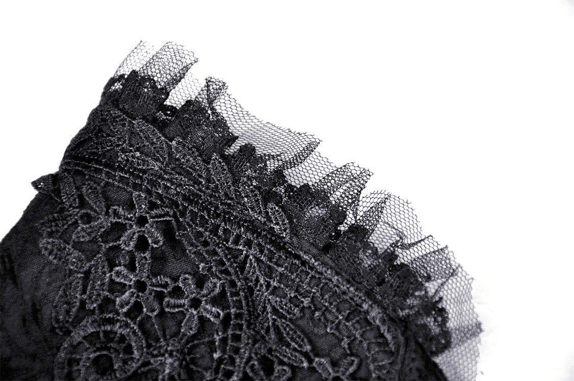 Close-up of intricate black lace design with frayed edges, perfect for a gothic lace skirt.
