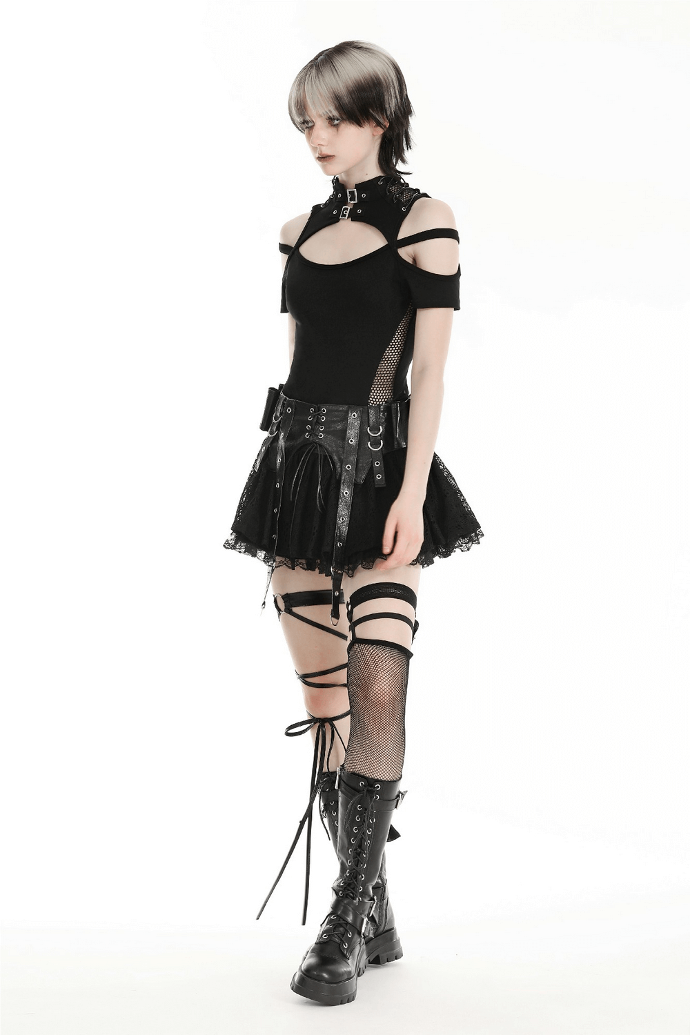 Edgy goth model in black lace skirt and corset, showcasing alternative fashion with stylish accessories and combat boots.