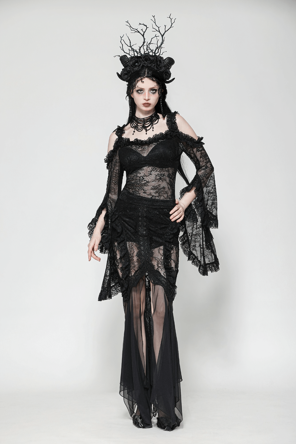 Gothic lace skirt with sheer mesh and high-low hem, paired with dark Victorian elegance and dramatic accessories.