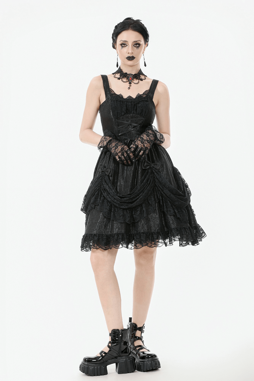 Gothic Lace Strap Dress with Ruffled Detailing and Lace Trim worn by a model, featuring lace gloves and chunky boots.