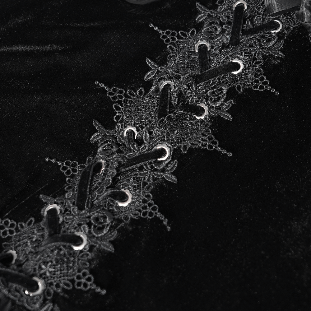 Gothic lace-up detail on black velvet blouse, featuring intricate floral lace trim and ribbons for a dramatic Victorian look.