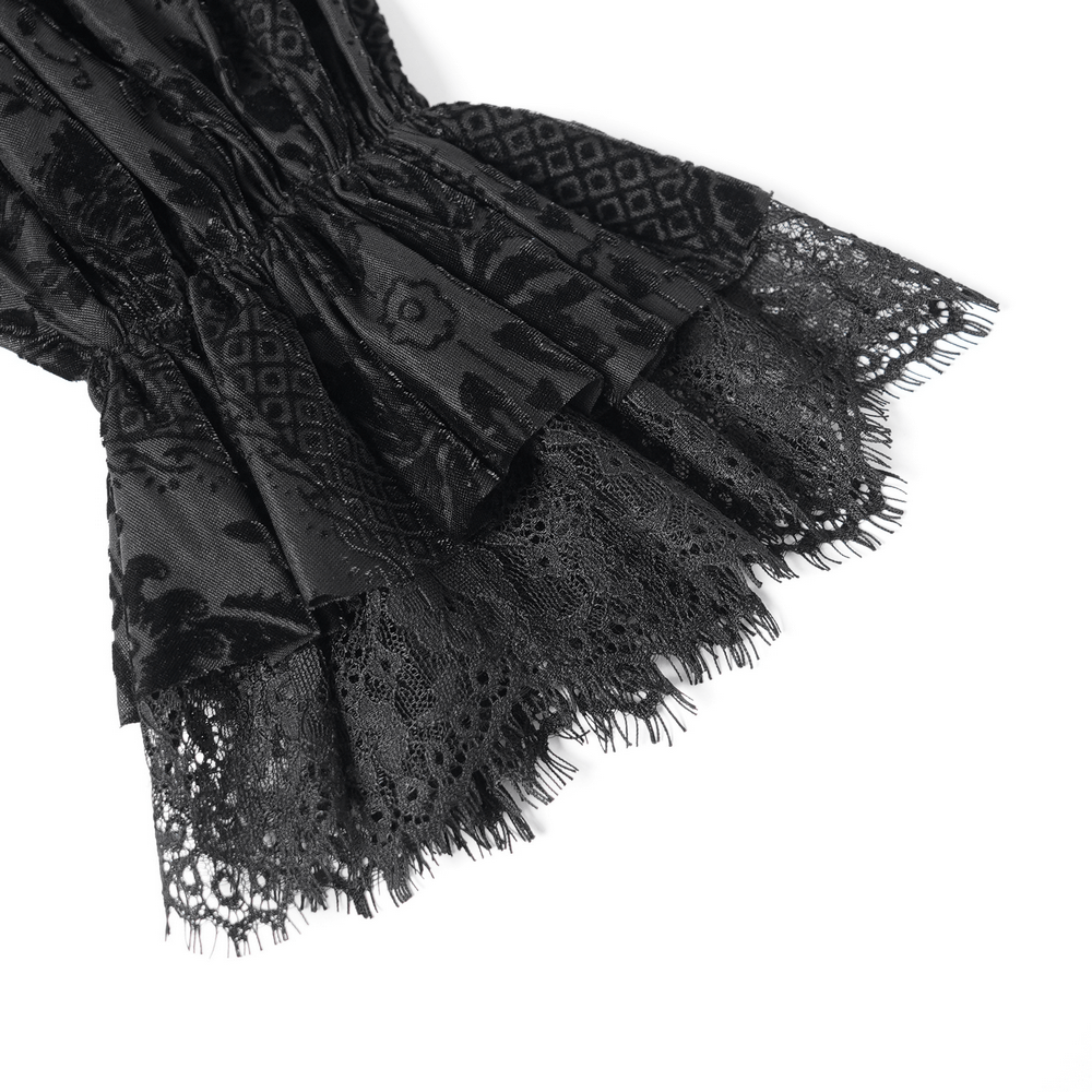 Close-up of gothic velvet blouse with intricate lace trim and floral details, embodying Victorian elegance.