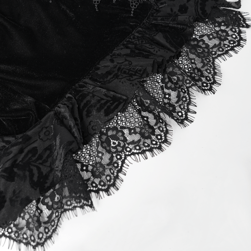 Close-up of black lace trim on velvet fabric, showcasing intricate floral details and frilly edges for a gothic blouse.