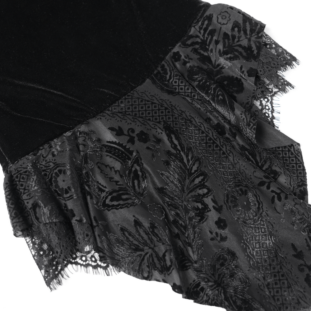 Close-up of gothic velvet blouse with floral lace trim and frilly hem, showcasing Victorian-inspired details.