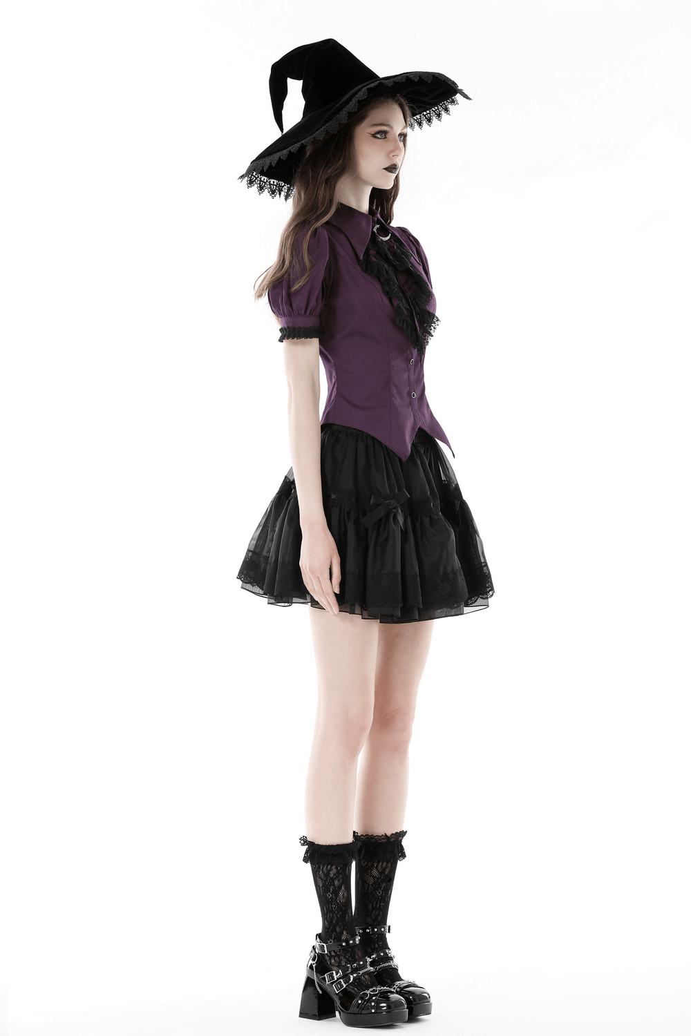 Model in Gothic lace-trimmed puff sleeves blouse with Victorian ruffles, paired with a witch hat and black skirt.