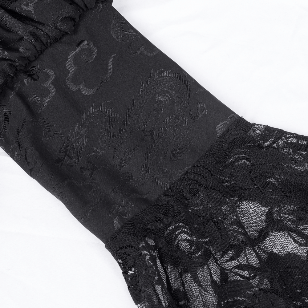 Close-up of gothic lace fabric with intricate patterns and flared lace sleeve details in black.