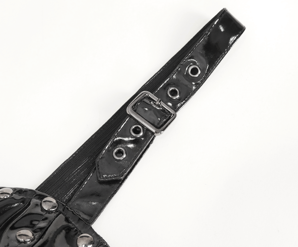 Close-up of adjustable shoulder strap with buckles and grommets from a gothic lace-up dress.