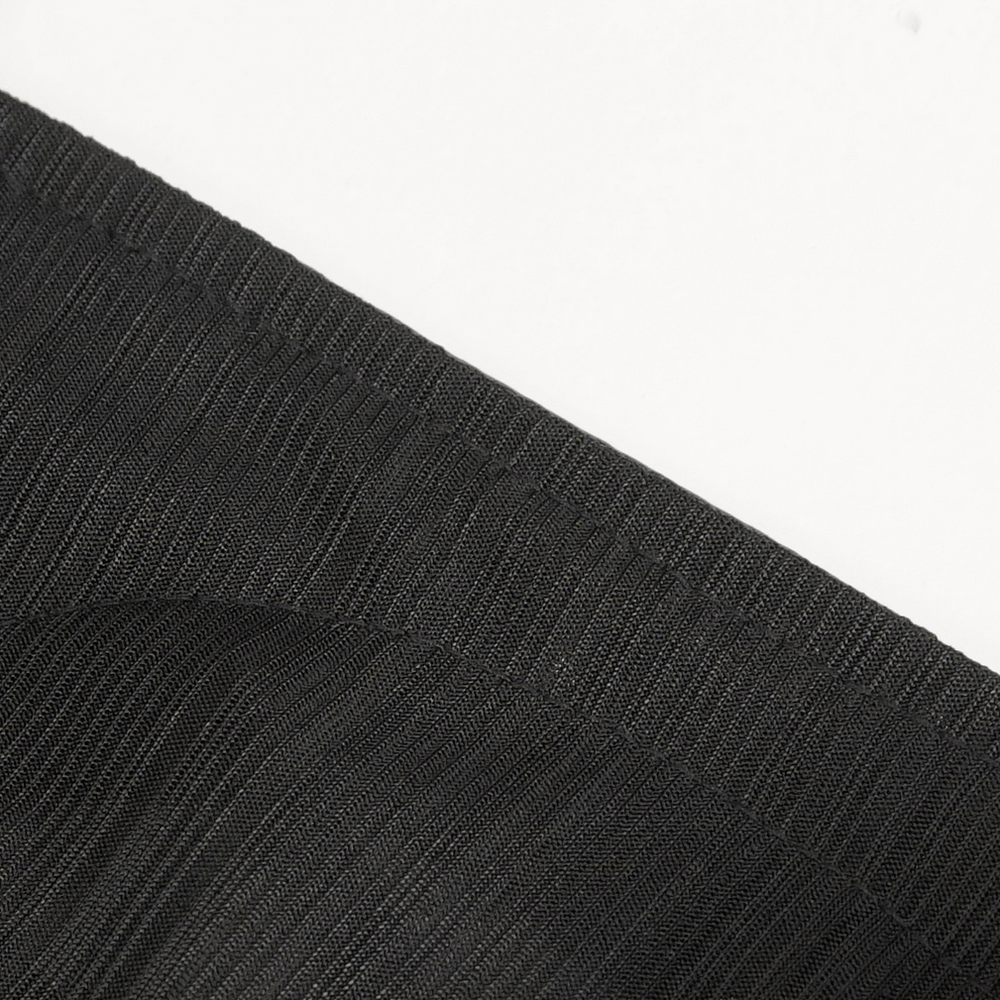 Close-up of black ribbed fabric showcasing intricate texture and stretch, ideal for gothic apparel.