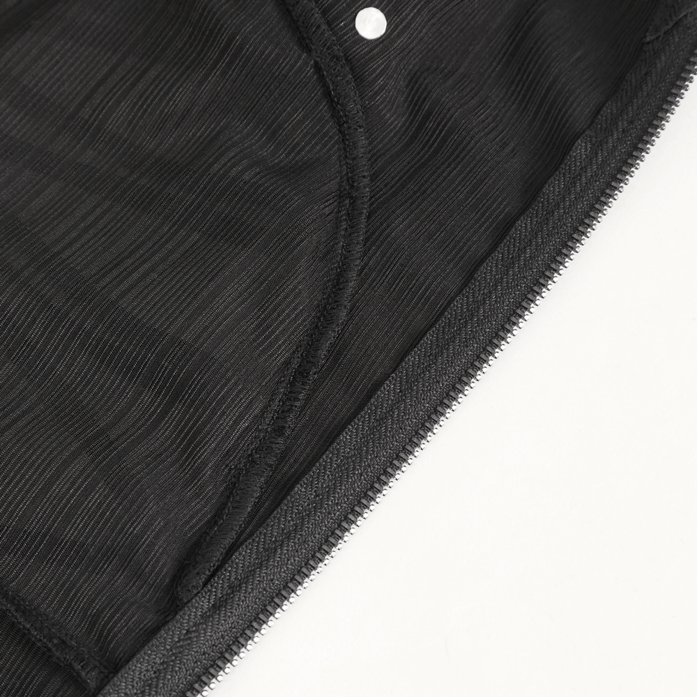 Close-up of black fabric with a zipper and scalloped detailing, showcasing gothic dress construction.