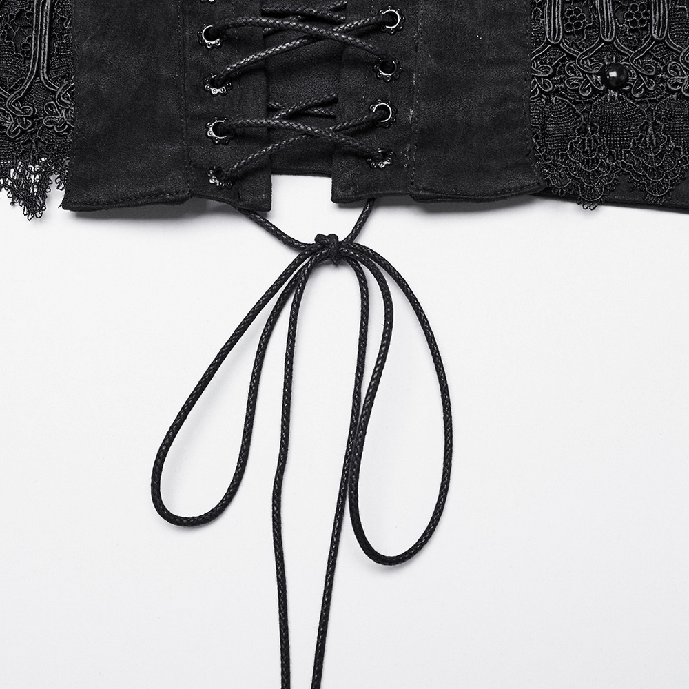 Close-up of Gothic lace-up black corset belt with intricate details and ribbon ties for a Victorian-inspired look.