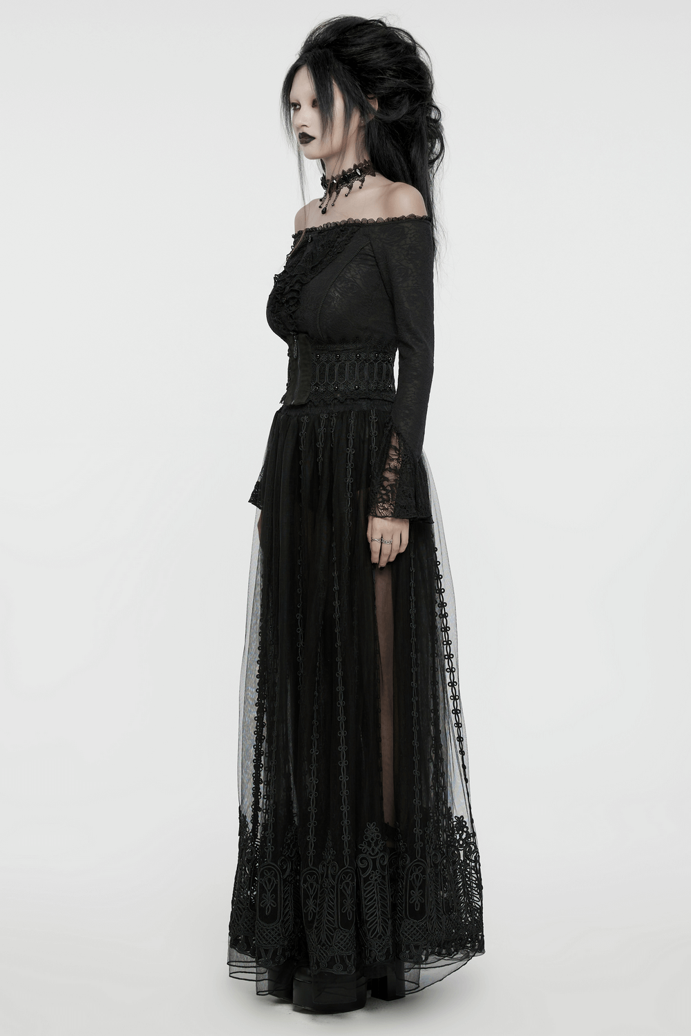 Elegant woman in a gothic black lace gown, highlighting Victorian style and intricate lace details.