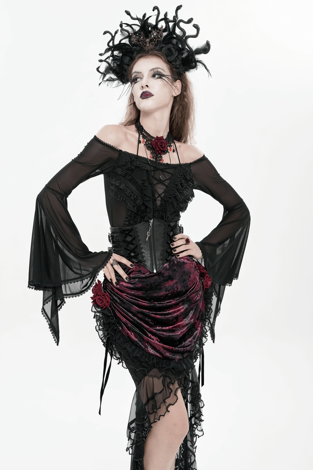 Gothic Lace-Up Black Corset Waist Belt with Cross Details worn with a dramatic gothic outfit featuring roses and flowing sleeves.