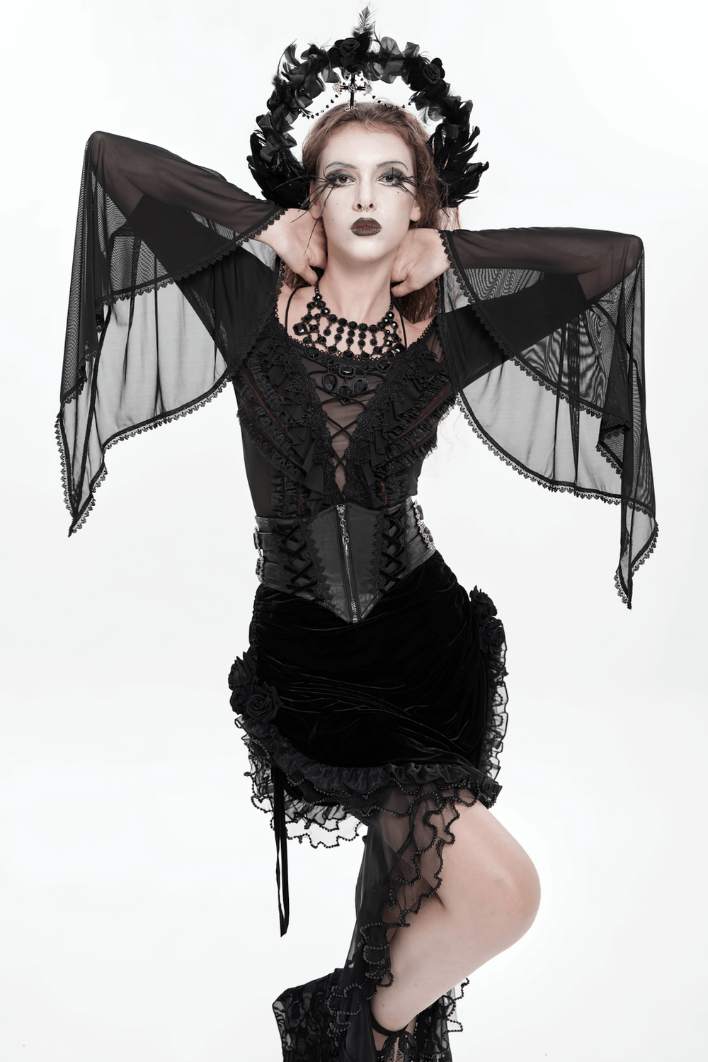 Gothic Lace-Up Black Corset Waist Belt with Cross Details styled in a dark romantic outfit with lace and sheer details.