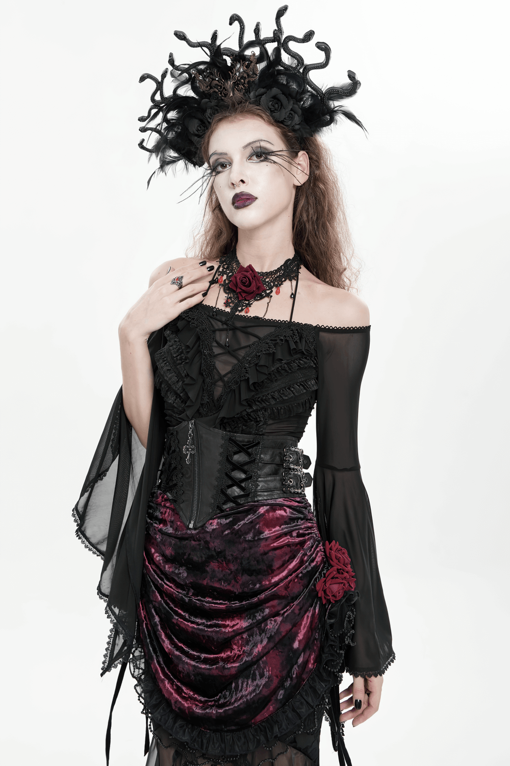 Gothic Lace-Up Black Corset Waist Belt with Cross Details worn by model in dramatic black dress and headpiece.