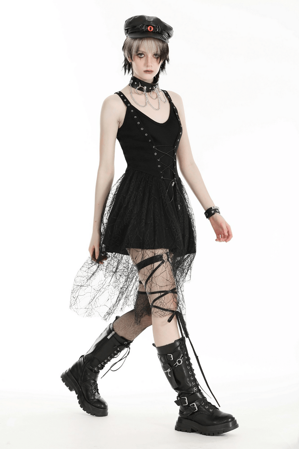 Gothic lace-up black dress with spider web details, stylishly worn with chunky boots and accessories.