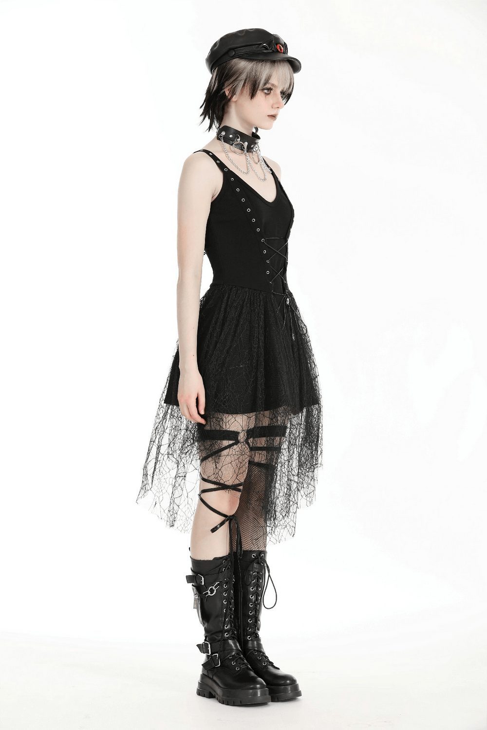Stylish gothic lace-up black dress with spider web mesh skirt and edgy accessories, perfect for a night out.
