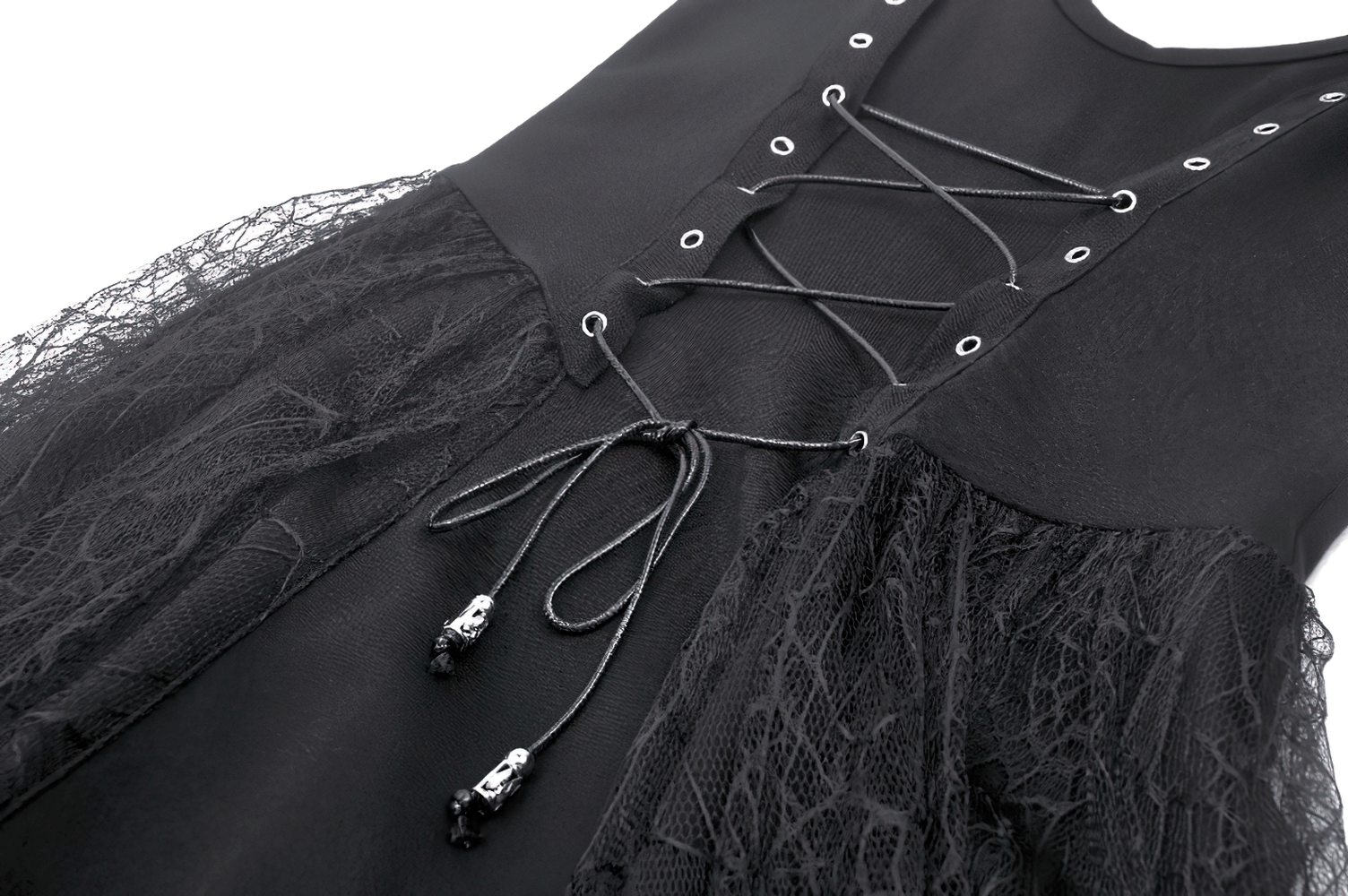 Close-up of lace-up black corset dress with spider web lace details and decorative skull accents.