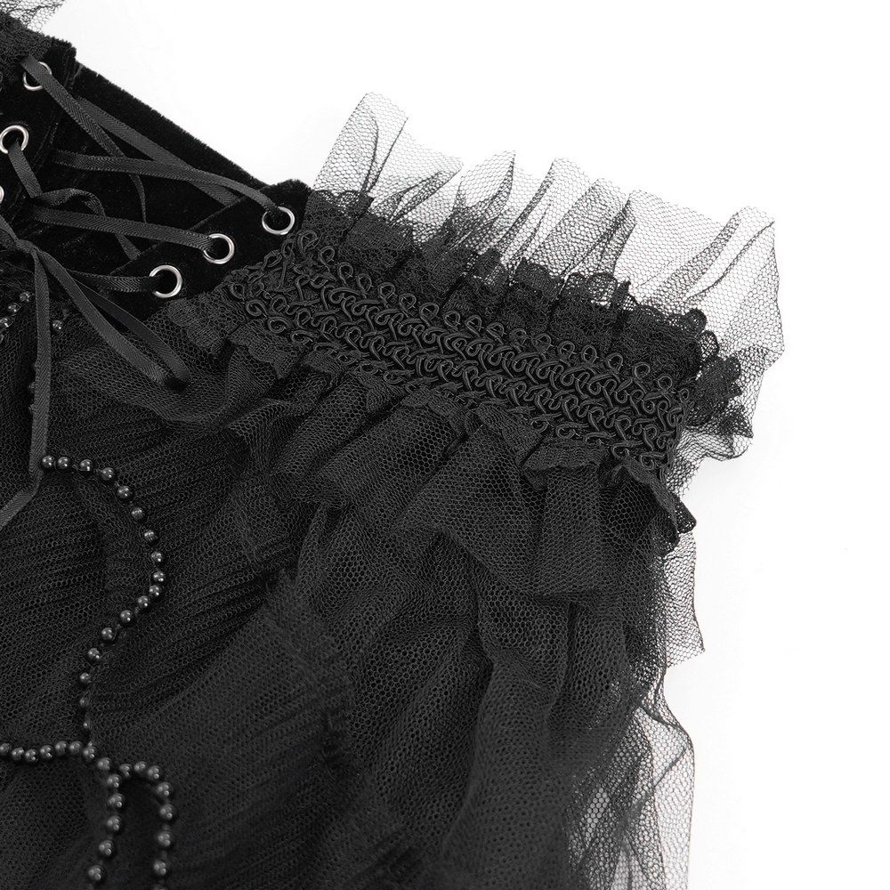 Close-up of black gothic lace-up shorts showcasing ruffled tulle and intricate beaded details for a bold edgy look.