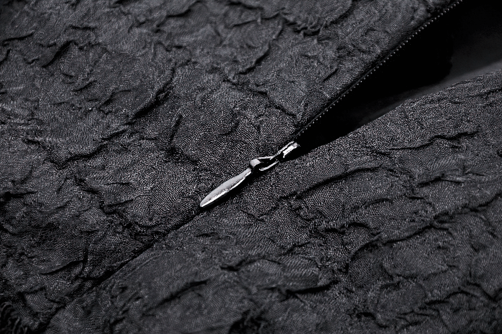 Close-up of a black textured fabric with a zipper, perfect detail for a Gothic lace-up dress design.
