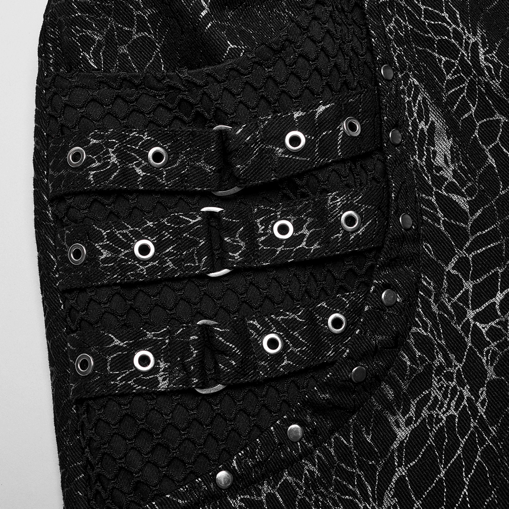 Close-up of gothic black twill pants with mesh accents and rivet details showcasing punk style.