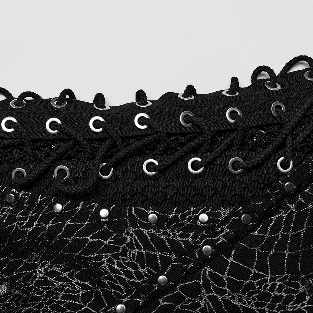 Close-up of black lace-up detailing with rivets on edgy men's punk pants, featuring mesh design and gothic elements.