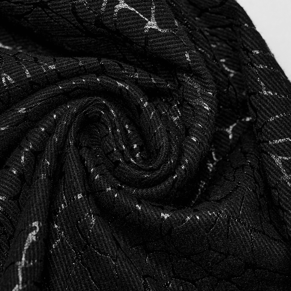 Close-up of black twill fabric with a unique embossed pattern, showcasing its texture and design for gothic flare pants.