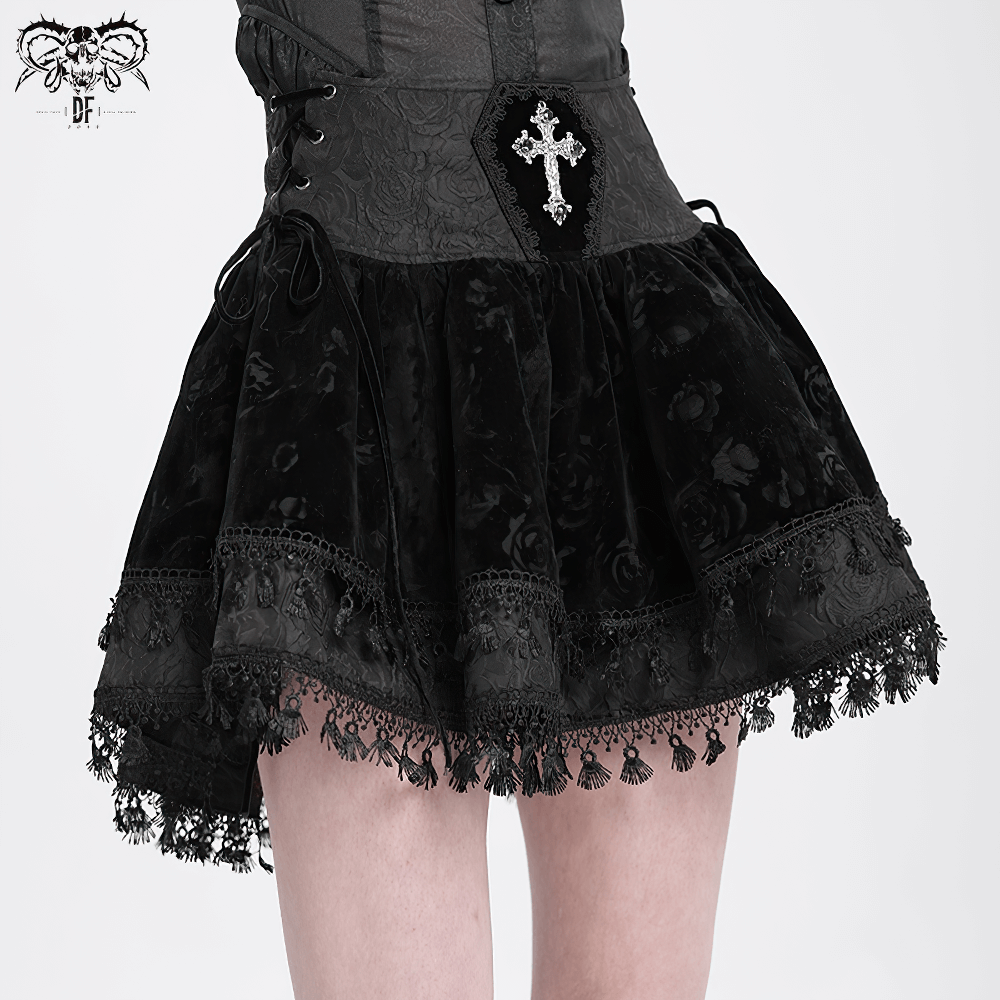 Gothic lace-up black velvet skirt with embroidered cross and tassel hem for a Victorian-inspired look.