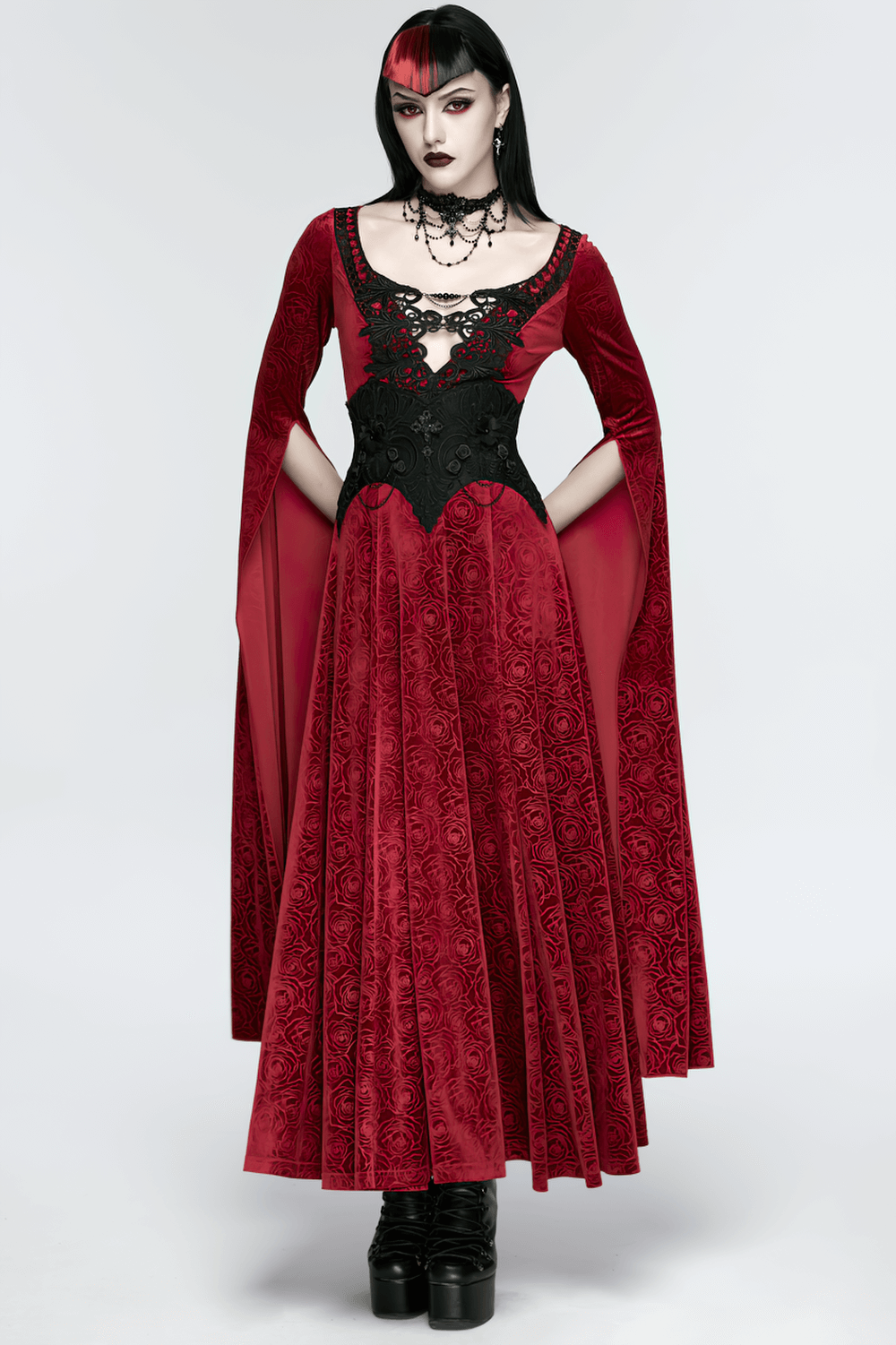 Gothic Lace-Up Corset Belt with Embroidery and Cross Details worn by a model in a striking red velvet dress.