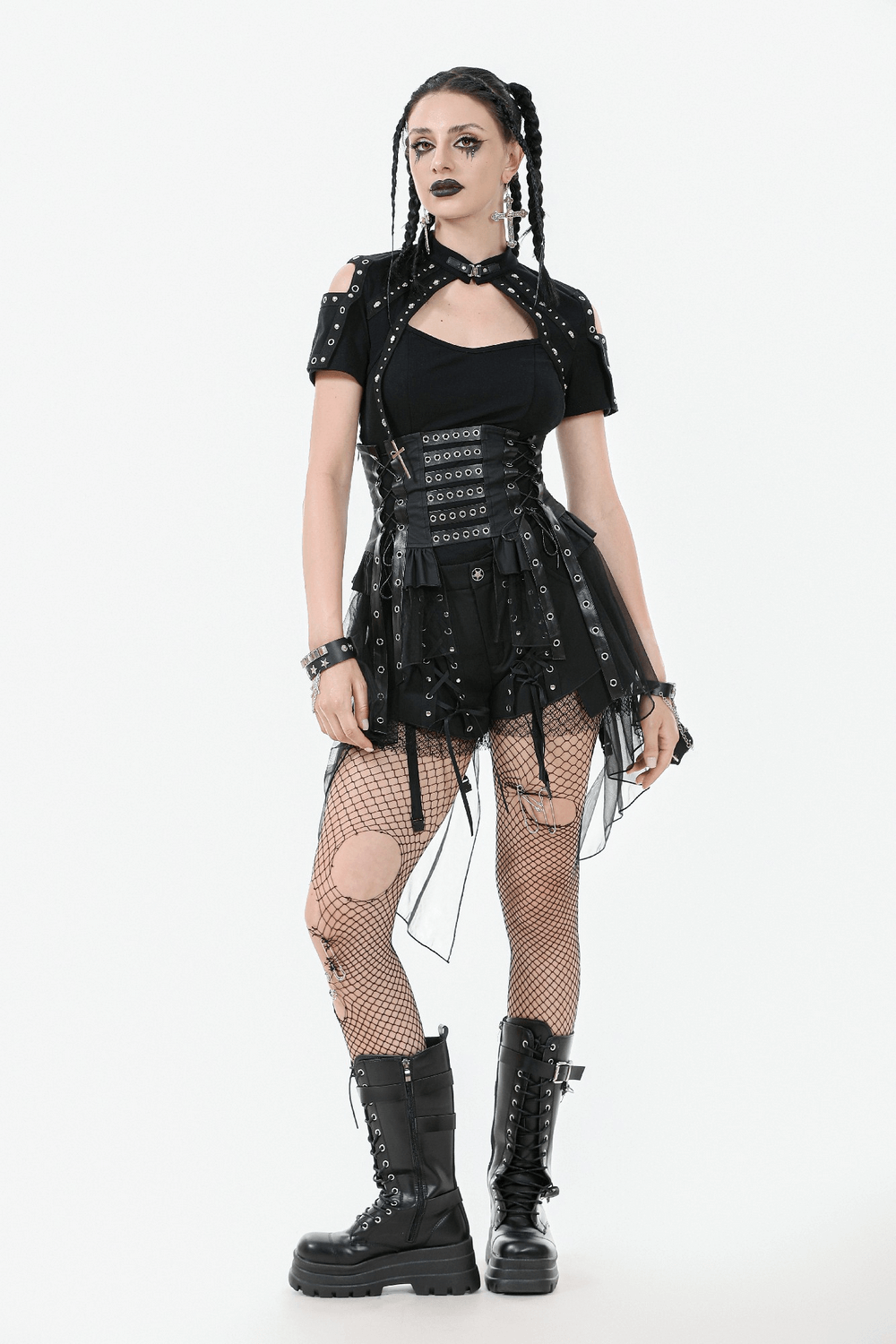 Gothic model in lace-up corset belt and layered tulle skirt, showcasing edgy fashion with fishnet tights and combat boots.