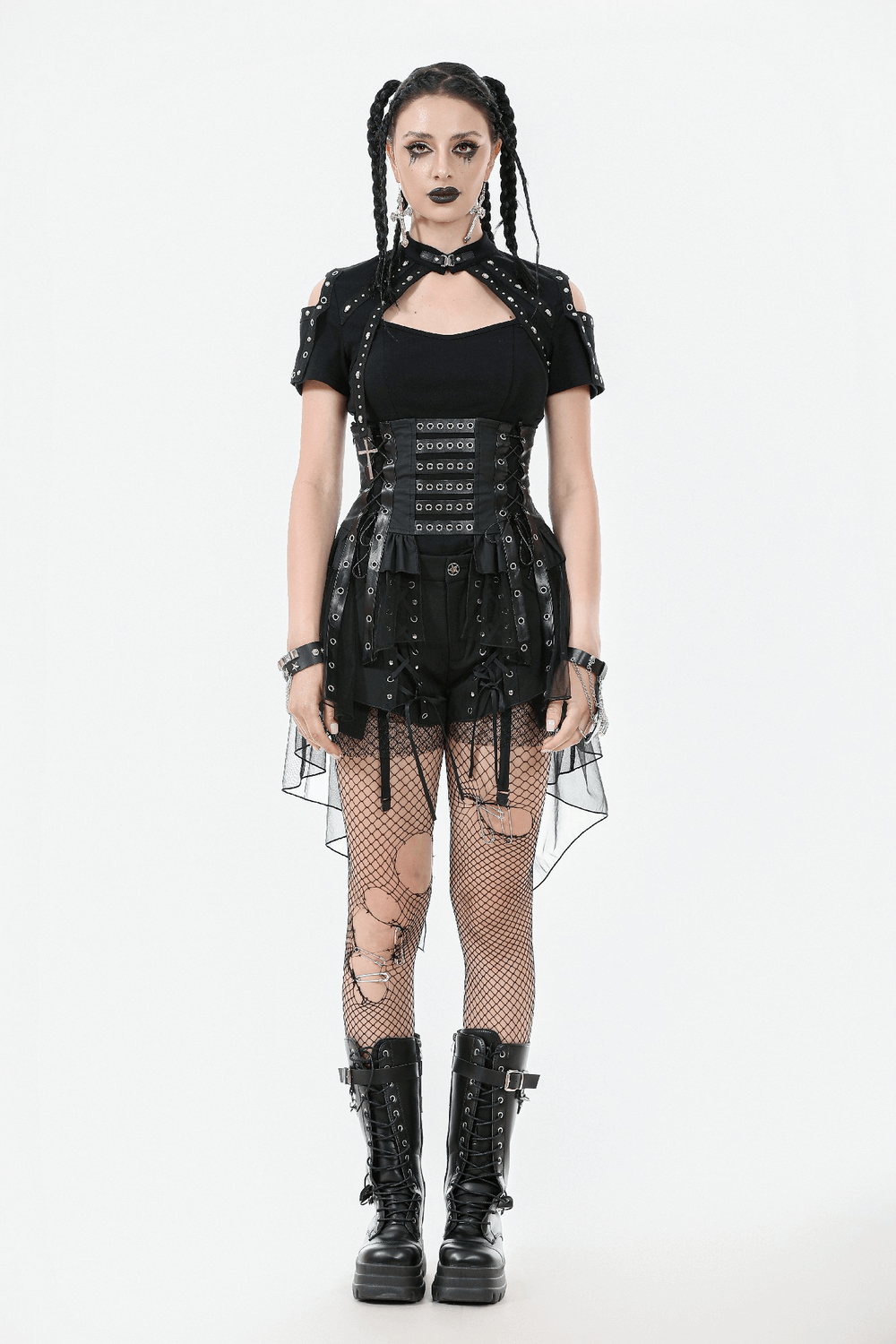 Gothic model wearing a lace-up corset belt with layered tulle skirt, edgy fishnet tights, and combat boots.