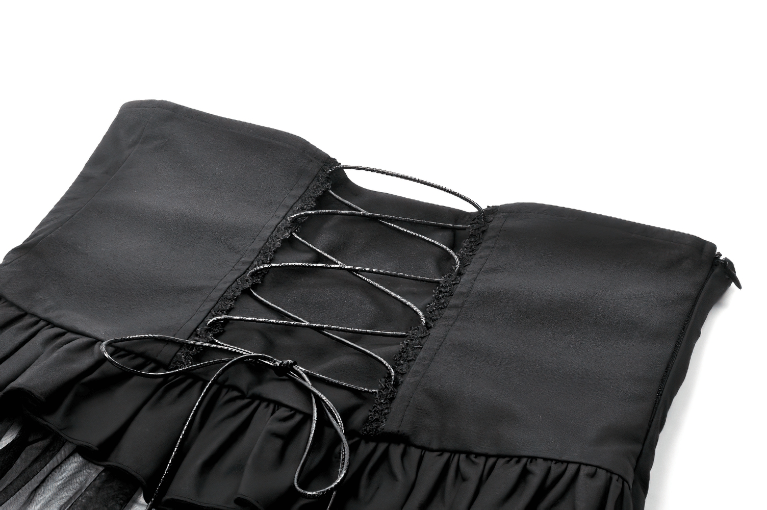 Close-up of a gothic lace-up corset belt in black satin with layered tulle and ruffled edges.