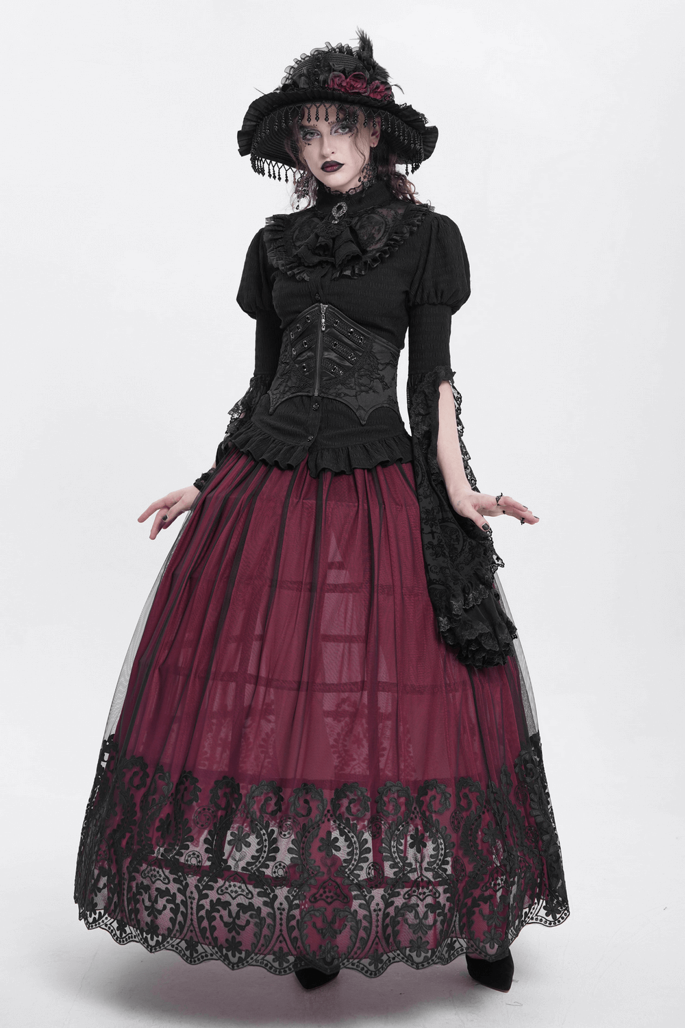 Gothic model in lace-up corset belt and layered burgundy skirt, showcasing edgy fashion style.