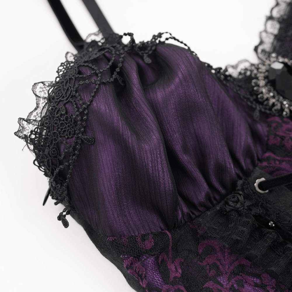 Close-up of gothic lace-up corset top featuring purple satin fabric, black floral lace, and intricate Victorian detailing.