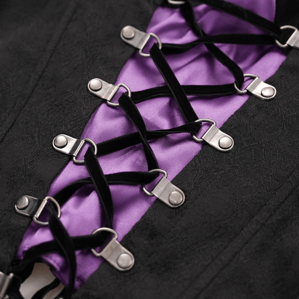 Close-up of Gothic lace-up corset top featuring intricate black and purple detailing with metal accents.