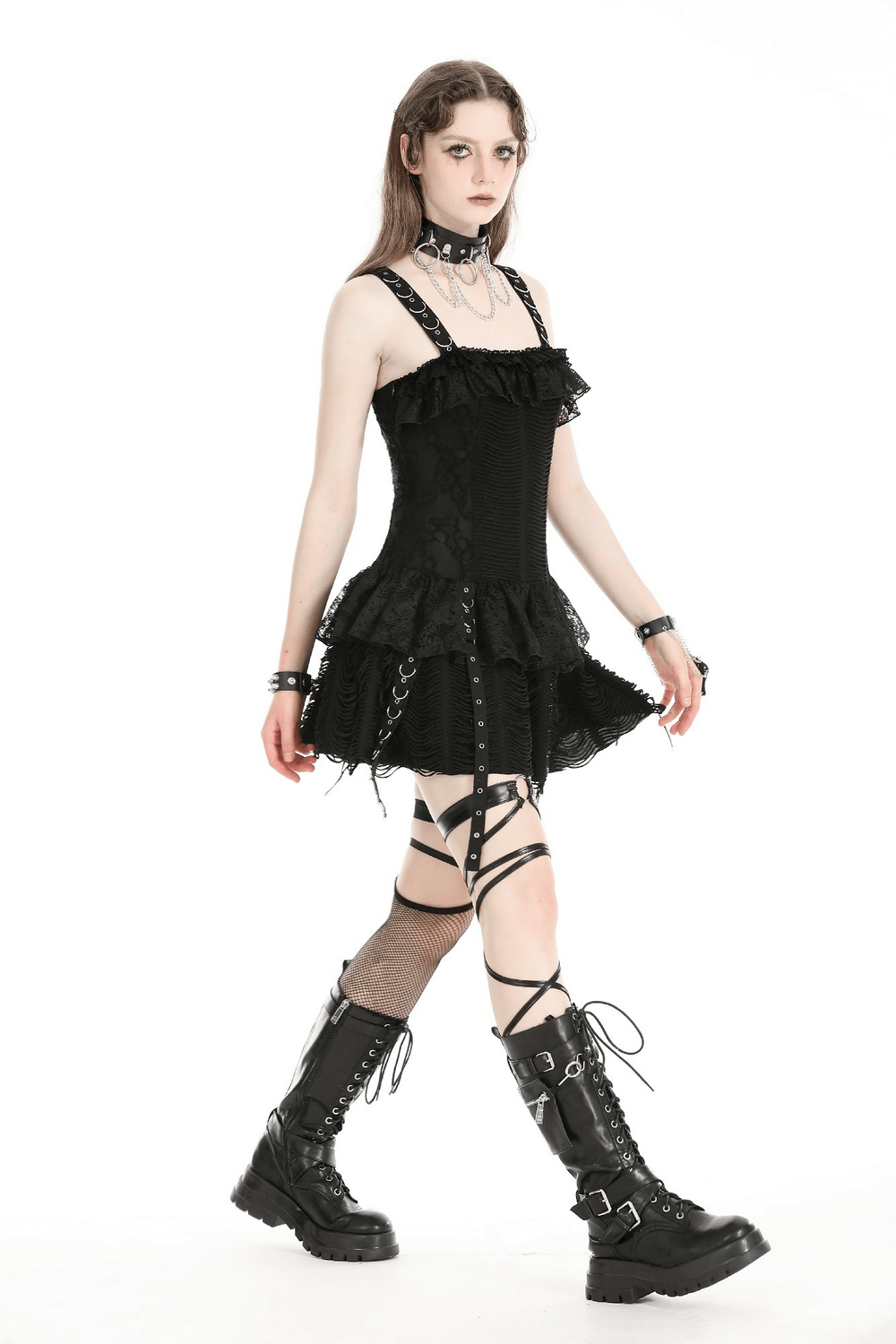 Gothic lace-up mini dress with ruffles and eyelet details, worn by model in black combat boots.