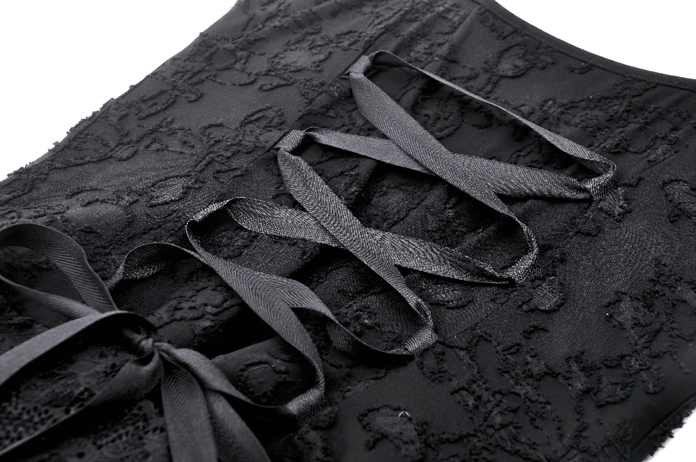 Close-up of the Gothic Lace-Up Dress with intricate lace and black ribbons crisscrossing for a steampunk look.