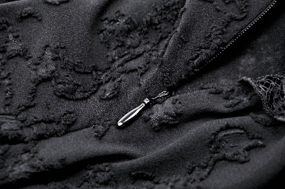 Close-up of black lace fabric with zipper detail, showcasing texture and elegance for gothic fashion lovers.