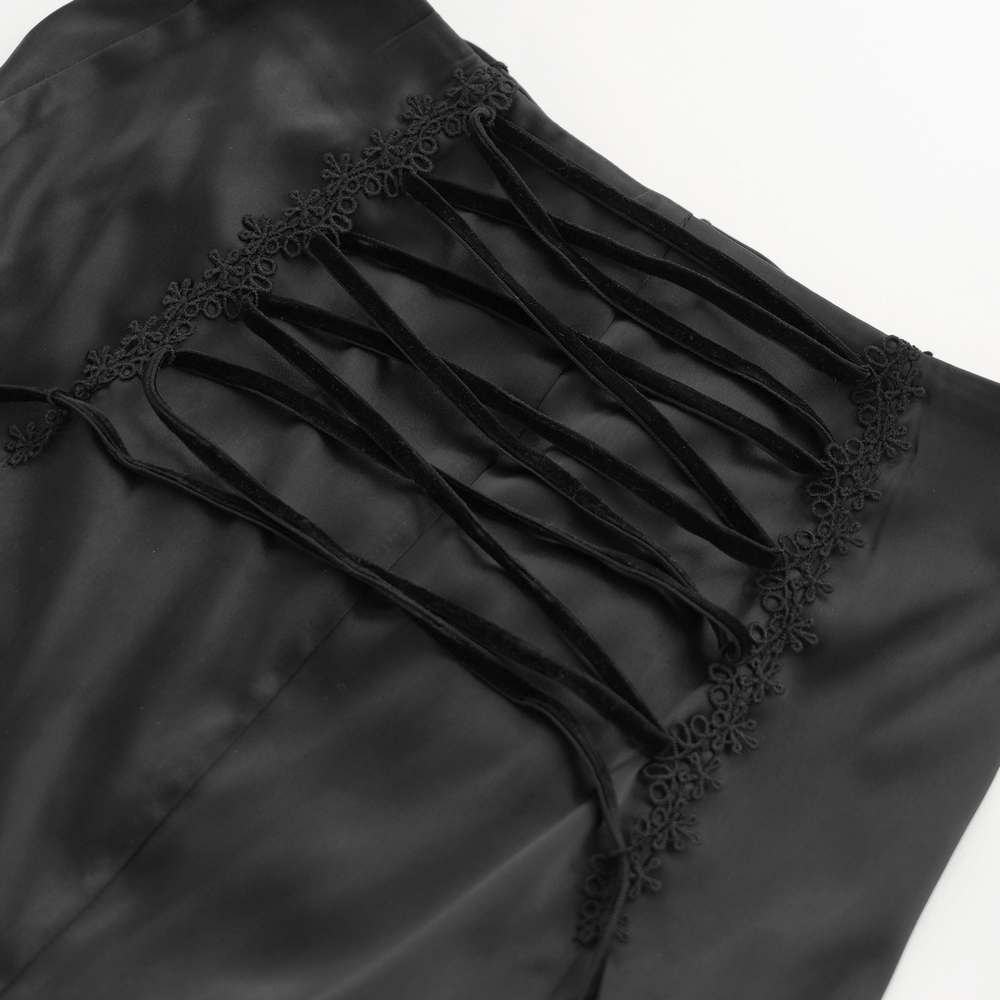Close-up of gothic lace-up detailing on a black skirt with floral accents and elegant velvet ties.