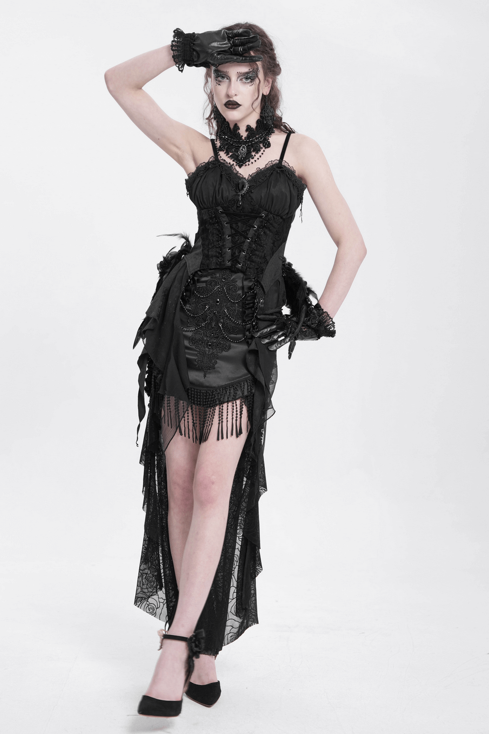 Gothic black skirt with lace-up details, fringe accents, and floral embroidery on a stylish model.