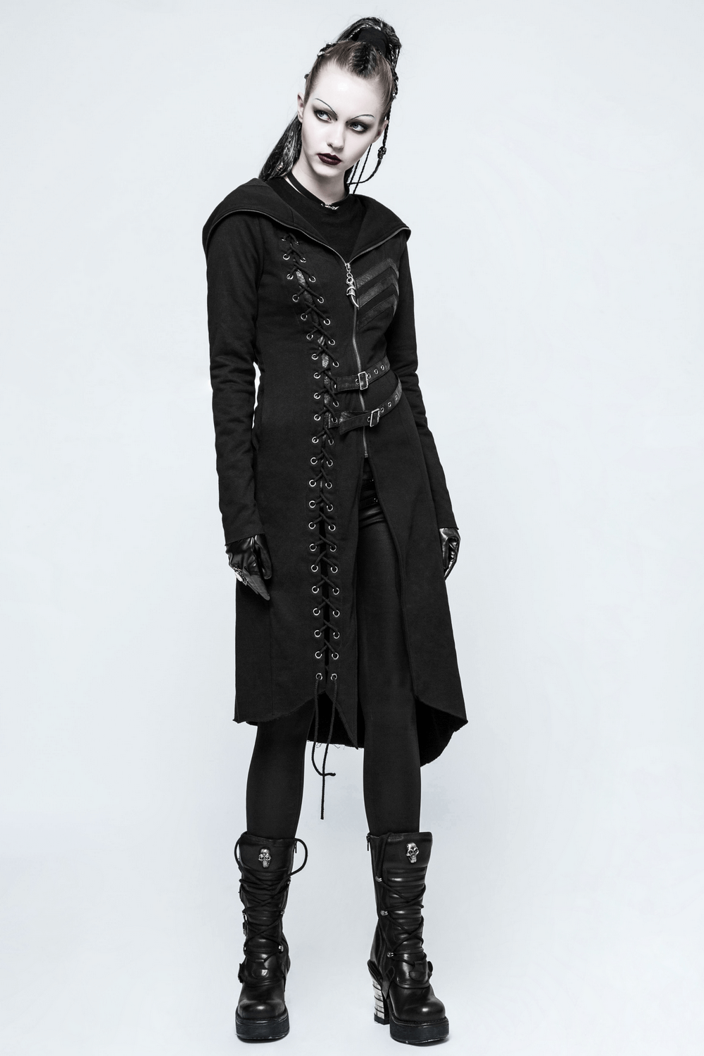 Gothic lace-up long coat with hood, buckles, and asymmetric hem worn by a fierce model.