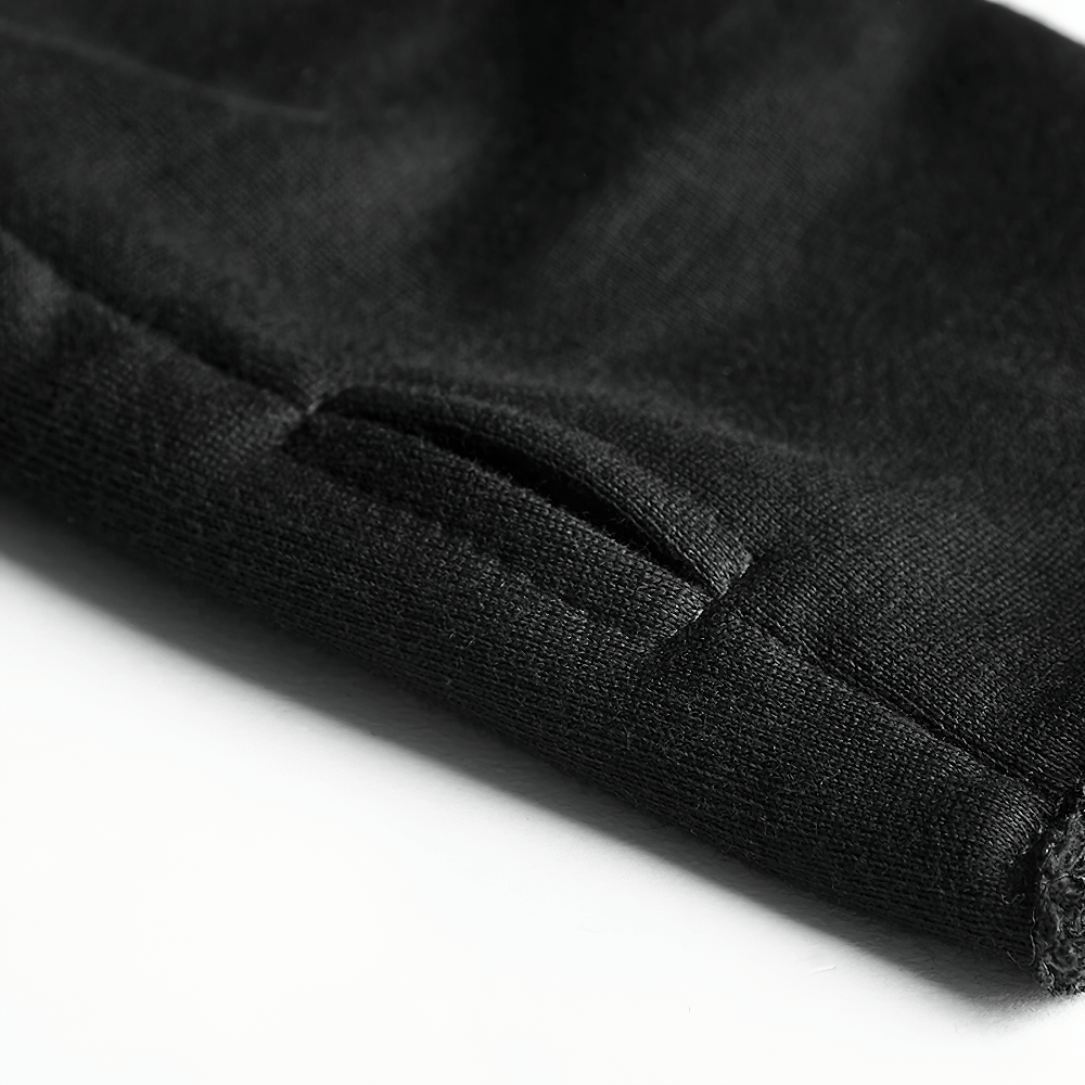 Close-up of a black coat sleeve featuring a stylish cut-out detail for a unique gothic flair.