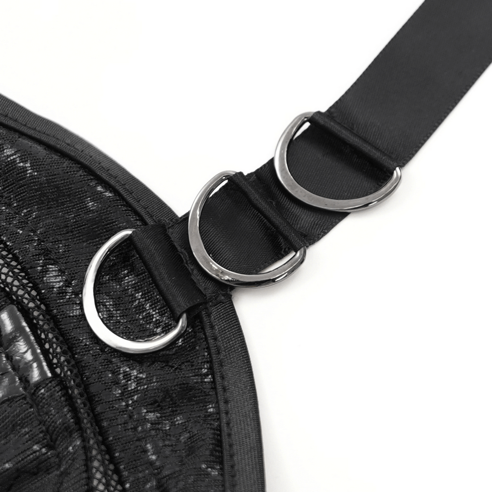 Close-up of metallic D-ring details on black lace adjustable straps for gothic-style dress.