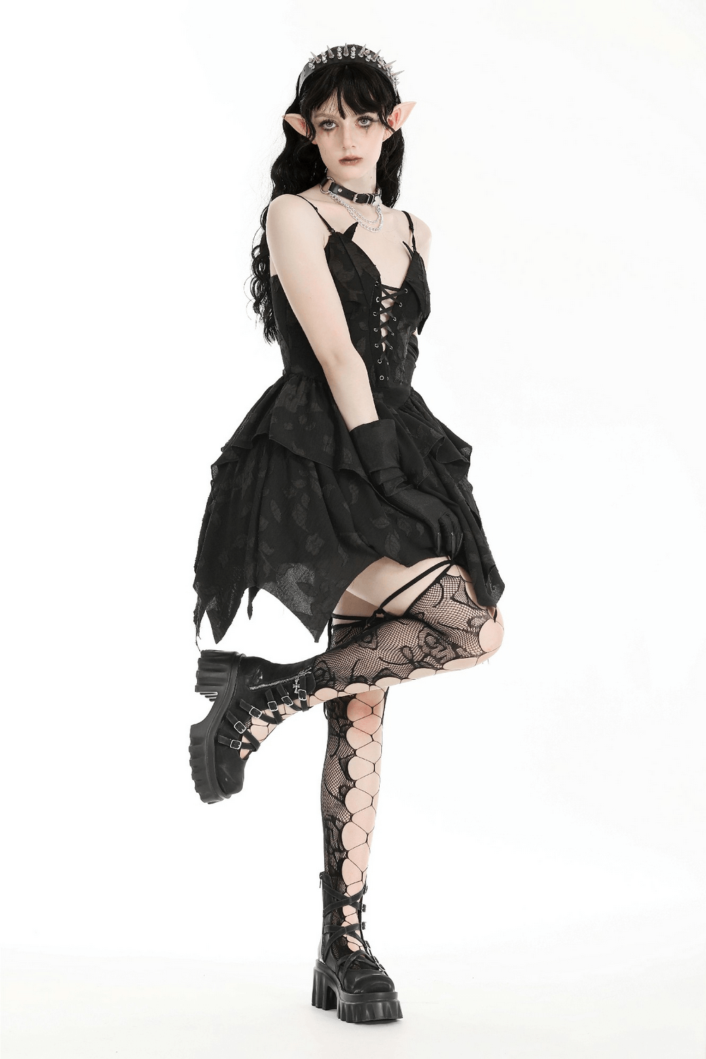 Gothic lace-up black dress with layered ruffles, stylish fishnet stockings, and chunky boots, embodying dark elegance.