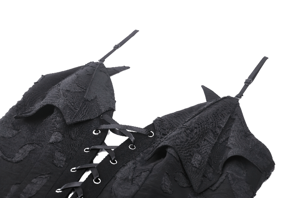 Close-up of Gothic lace-up black dress with ruffled detailing and adjustable straps.