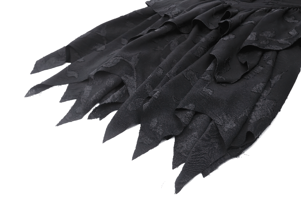 Close-up of jagged hemline on Gothic lace-up ruffled black dress, showcasing layered ruffles in a dark aesthetic.