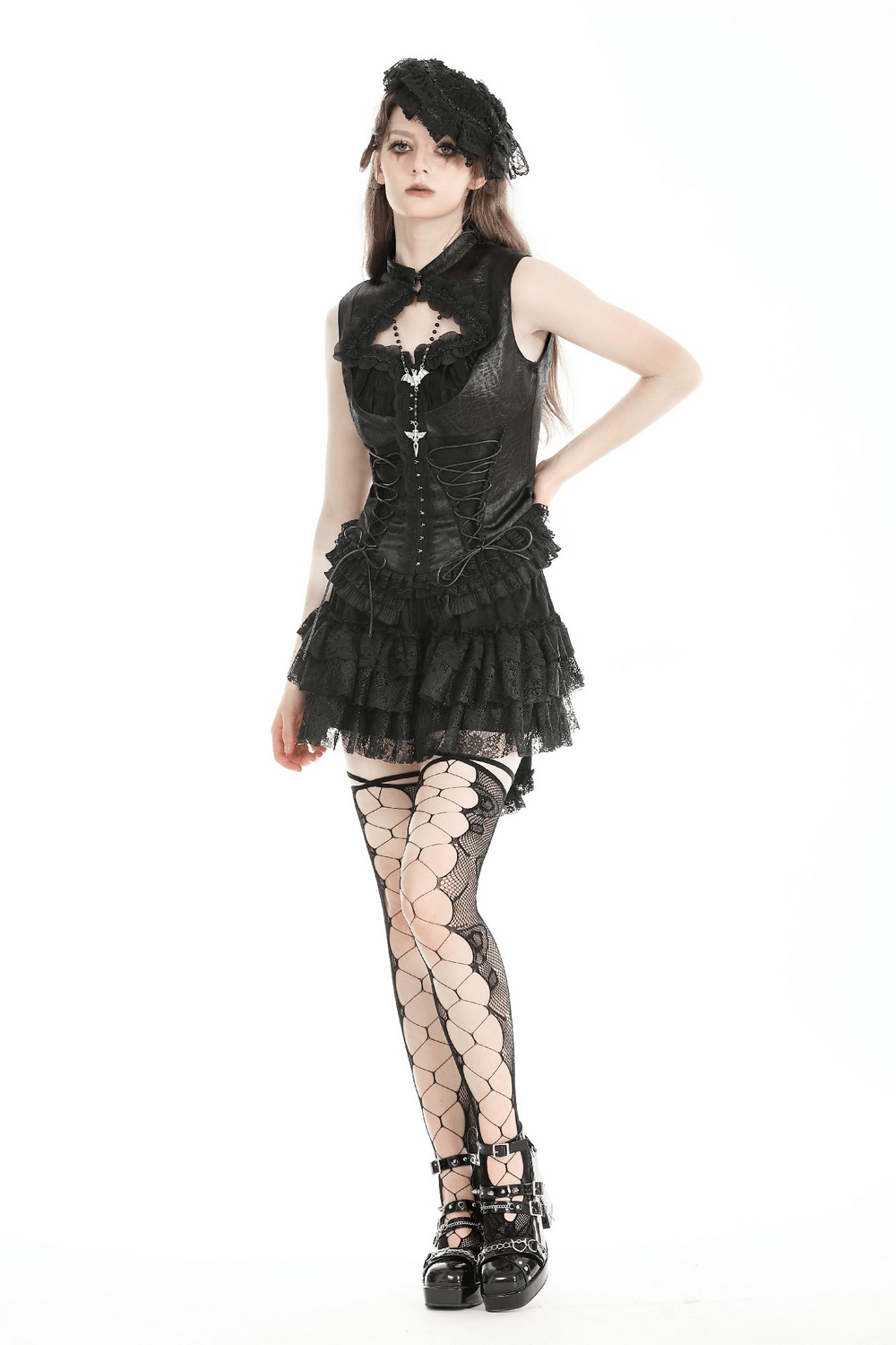 Gothic lace-up sleeveless top with ruffled trim and fishnet stockings, showcasing a Victorian-inspired style.